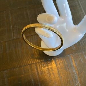 A vintage mother of pearl or like mater and gold-tone segmented bangle bracelet.